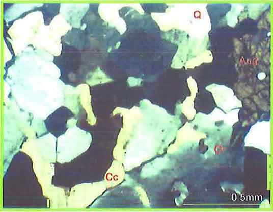 Interstitial Calcite Grains Among K-Feldspar And Quartz With Augite photomicrogaph image