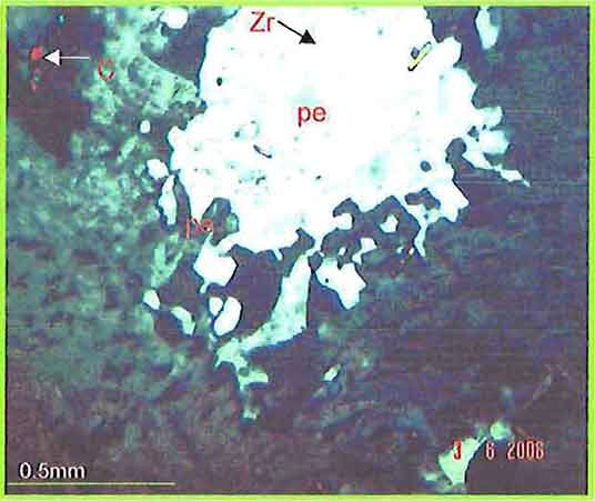 K-Feldspar With Flame Perthite Enclosing Zircon Crystal And Corundum Grain photomicrogaph image